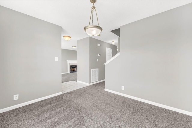 1373 Mackenzie Ct, Clarksville, TN 37042 - unfurnished room featuring light carpet, a tiled fireplace, and light tile patterned floors