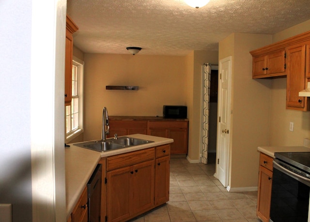 109 Hunter Dr, Mount Juliet, TN 37122 - kitchen featuring appliances with stainless steel finishes, brown cabinets, light countertops, a textured ceiling, and light tile patterned floors