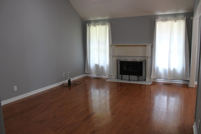 109 Hunter Dr, Mount Juliet, TN 37122 - unfurnished living room featuring vaulted ceiling, wood finished floors, and a fireplace with raised hearth