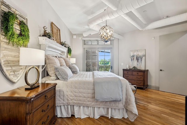 320 Liberty Pike Unit 205, Franklin, TN 37064 - bedroom with wood finished floors, a chandelier, and access to exterior