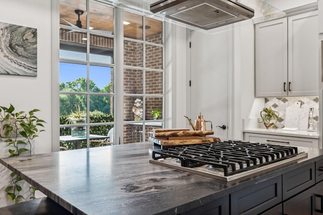 320 Liberty Pike Unit 205, Franklin, TN 37064 - kitchen with exhaust hood, stainless steel gas cooktop, plenty of natural light, and backsplash