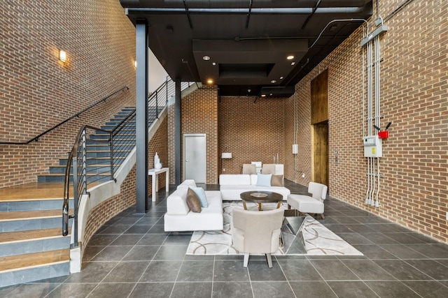 320 Liberty Pike Unit 205, Franklin, TN 37064 - common area with a high ceiling, stairway, and brick wall