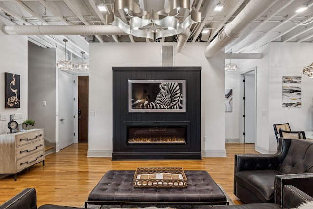 320 Liberty Pike Unit 205, Franklin, TN 37064 - living room featuring light wood finished floors and a large fireplace