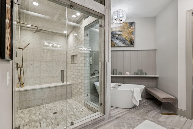 320 Liberty Pike Unit 205, Franklin, TN 37064 - bathroom featuring a freestanding tub, a stall shower, and a chandelier