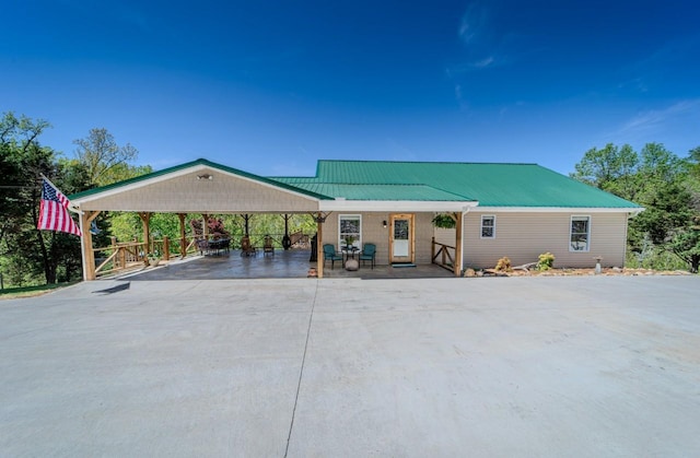 3205 Rocky Point Ln, Stewart, TN 37175 - view of front of house with concrete driveway, a detached carport, and a metal roof