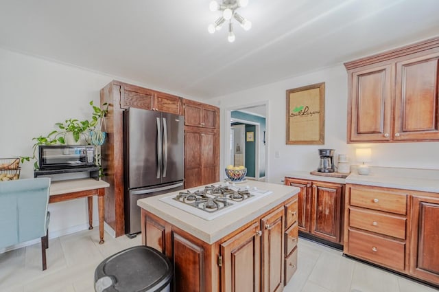 3205 Rocky Point Ln, Stewart, TN 37175 - kitchen featuring freestanding refrigerator, white gas cooktop, light countertops, and a kitchen island