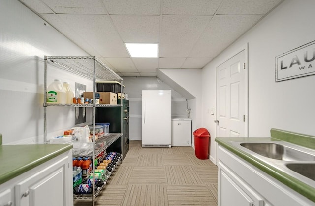 3205 Rocky Point Ln, Stewart, TN 37175 - kitchen featuring a drop ceiling, white cabinets, and freestanding refrigerator