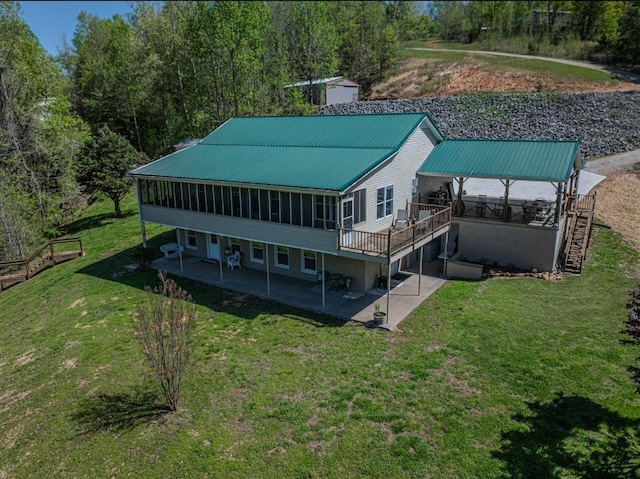 3205 Rocky Point Ln, Stewart, TN 37175 - rear view of property featuring a patio, a sunroom, stairs, a lawn, and a metal roof