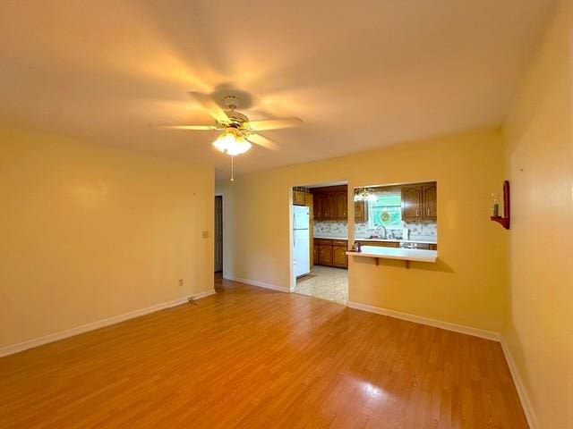 104 Tobaccoport Dock Rd, Bumpus Mills, TN 37028 - unfurnished living room with light wood-style floors and a ceiling fan