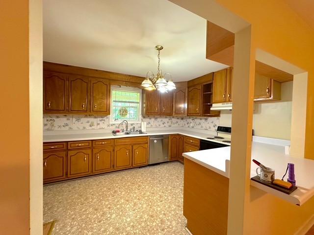 104 Tobaccoport Dock Rd, Bumpus Mills, TN 37028 - kitchen with dishwasher, brown cabinetry, under cabinet range hood, a chandelier, and light countertops