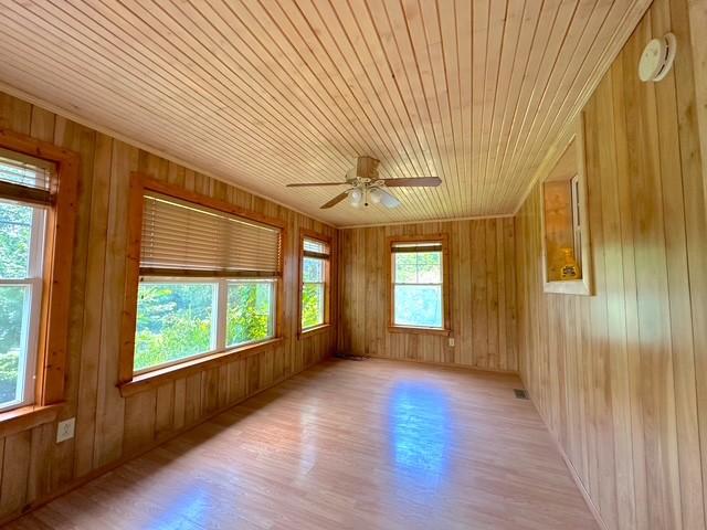 104 Tobaccoport Dock Rd, Bumpus Mills, TN 37028 - empty room with light wood-style floors, ceiling fan, wooden walls, and wooden ceiling