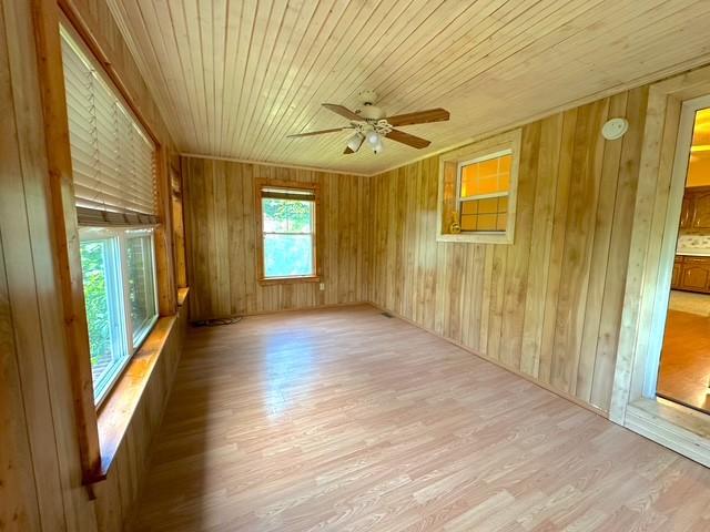 104 Tobaccoport Dock Rd, Bumpus Mills, TN 37028 - spare room featuring wood finished floors, ceiling fan, wood walls, and wood ceiling