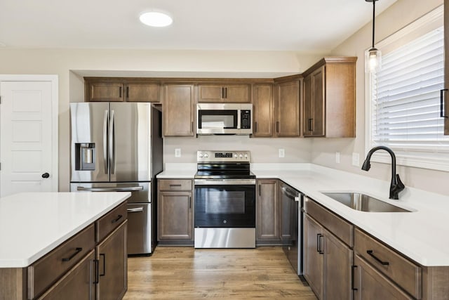 145 Irish Hls, Clarksville, TN 37042 - kitchen featuring stainless steel appliances, hanging light fixtures, light wood finished floors, and light countertops