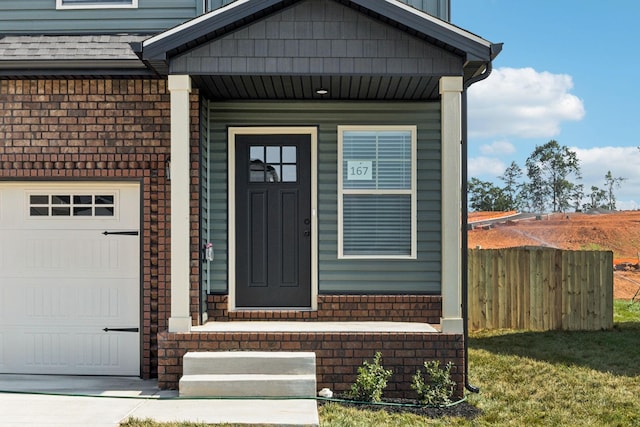145 Irish Hls, Clarksville, TN 37042 - view of exterior entry with brick siding, a porch, and a garage