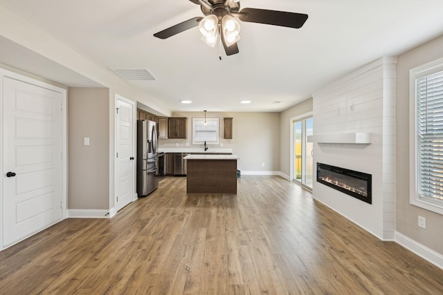 145 Irish Hls, Clarksville, TN 37042 - kitchen with stainless steel appliances, light countertops, open floor plan, a ceiling fan, and dark brown cabinets