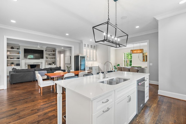 4220 Kirtland Rd, Nashville, TN 37215 - kitchen featuring crown molding, a kitchen island with sink, beverage cooler, white cabinetry, and pendant lighting