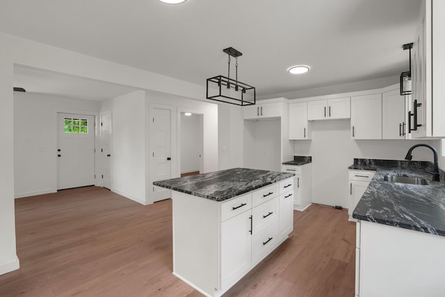 306 Forrest St, Watertown, TN 37184 - kitchen featuring dark stone counters, light wood-type flooring, and white cabinets