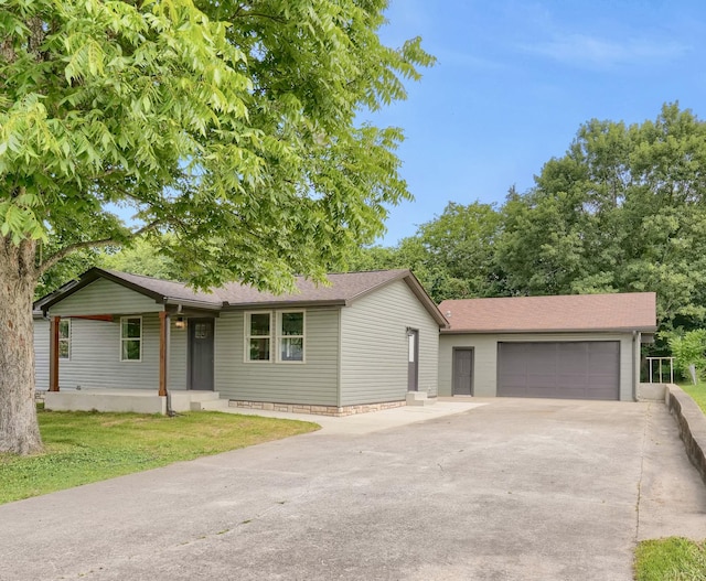 306 Forrest St, Watertown, TN 37184 - ranch-style house featuring concrete driveway, a garage, and roof with shingles