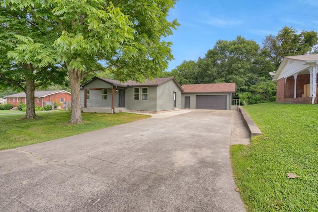 306 Forrest St, Watertown, TN 37184 - ranch-style house featuring driveway, a front lawn, an attached garage, and an outdoor structure
