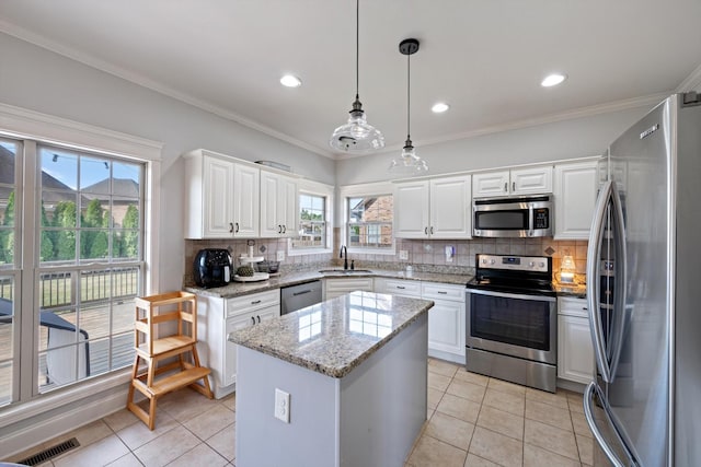 312 Retriever Ct, Clarksville, TN 37043 - kitchen featuring stainless steel appliances, a center island, decorative backsplash, white cabinetry, and recessed lighting