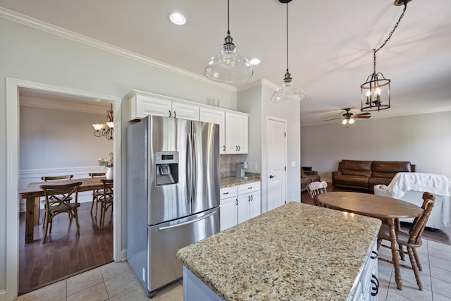 312 Retriever Ct, Clarksville, TN 37043 - kitchen with stainless steel refrigerator with ice dispenser, a chandelier, ornamental molding, white cabinets, and a ceiling fan