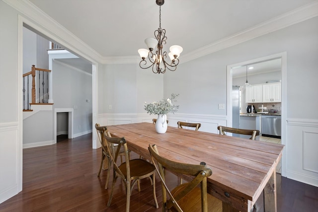 312 Retriever Ct, Clarksville, TN 37043 - dining area featuring dark wood-style flooring, a chandelier, crown molding, and a wainscoted wall
