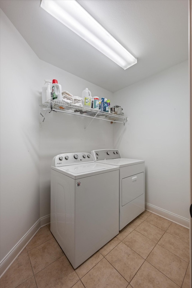 312 Retriever Ct, Clarksville, TN 37043 - laundry area with washer and clothes dryer and light tile patterned flooring