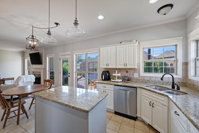 312 Retriever Ct, Clarksville, TN 37043 - kitchen with dishwasher, light tile patterned flooring, plenty of natural light, a kitchen island, and crown molding