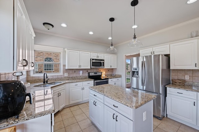 312 Retriever Ct, Clarksville, TN 37043 - kitchen with appliances with stainless steel finishes, crown molding, a center island, tasteful backsplash, and white cabinets