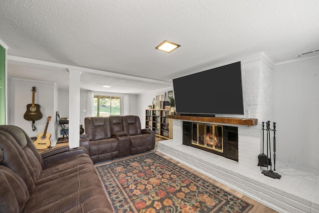 236 Slayden Cir, Clarksville, TN 37040 - living area featuring a textured ceiling, a brick fireplace, crown molding, and wood finished floors