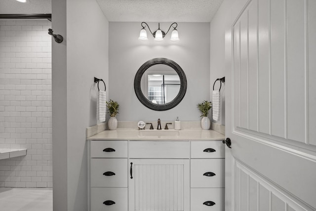 236 Slayden Cir, Clarksville, TN 37040 - bathroom featuring a tile shower, vanity, and a textured ceiling