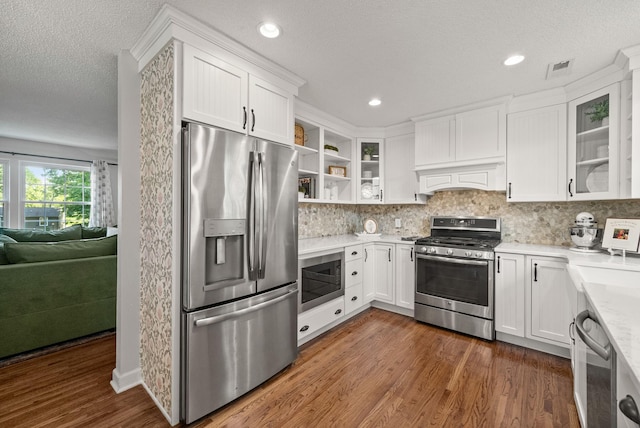 236 Slayden Cir, Clarksville, TN 37040 - kitchen featuring appliances with stainless steel finishes, dark wood-style flooring, white cabinets, decorative backsplash, and a textured ceiling