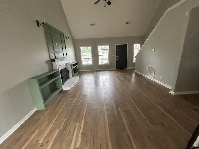 3421 Foxrun Ln, Clarksville, TN 37042 - unfurnished living room featuring ceiling fan, wood finished floors, a fireplace with raised hearth, and high vaulted ceiling