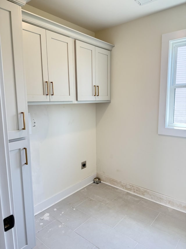 317 Wesson Dr, Clarksville, TN 37043 - washroom with electric dryer hookup, cabinet space, and light tile patterned floors