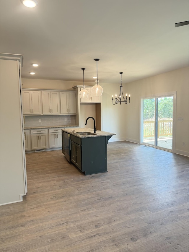 317 Wesson Dr, Clarksville, TN 37043 - kitchen with light wood-style flooring, recessed lighting, light stone countertops, hanging light fixtures, and a chandelier