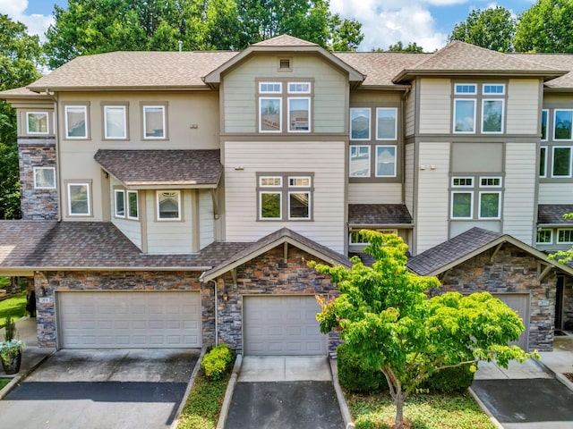 320 Old Hickory Blvd Unit 2103, Nashville, TN 37221 - view of front of home with stone siding, driveway, and a shingled roof