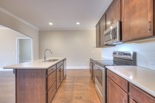 213 Vintage Way, Lebanon, TN 37087 - kitchen with appliances with stainless steel finishes, crown molding, tasteful backsplash, an island with sink, and light wood finished floors