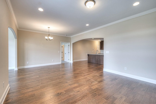 213 Vintage Way, Lebanon, TN 37087 - unfurnished living room with arched walkways, a chandelier, ornamental molding, dark wood-style flooring, and recessed lighting