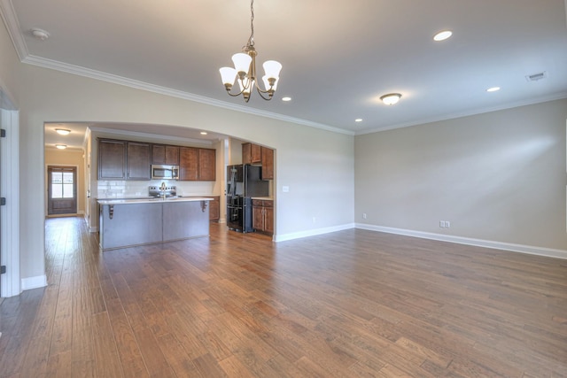 213 Vintage Way, Lebanon, TN 37087 - unfurnished living room with arched walkways, a chandelier, dark wood-style flooring, ornamental molding, and recessed lighting