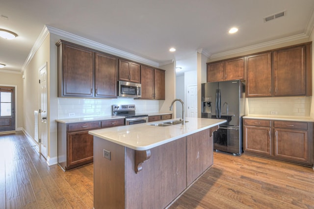 213 Vintage Way, Lebanon, TN 37087 - kitchen with stainless steel appliances, ornamental molding, wood finished floors, backsplash, and a kitchen island with sink