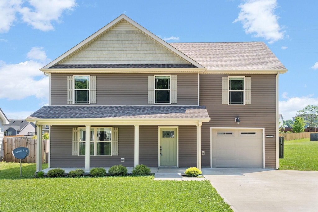 531 Tracy Ln, Clarksville, TN 37040 - view of front of property featuring concrete driveway, an attached garage, a porch, and roof with shingles