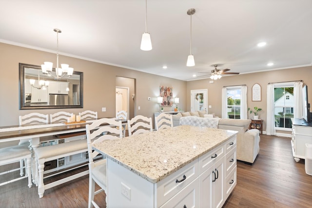 204 Locust St, Mc Ewen, TN 37101 - kitchen featuring a chandelier, white cabinets, crown molding, a kitchen island, and light stone countertops