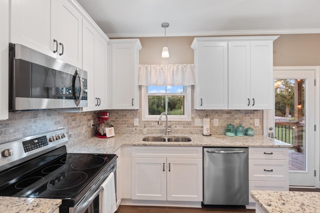 204 Locust St, Mc Ewen, TN 37101 - kitchen featuring appliances with stainless steel finishes, white cabinets, backsplash, light stone countertops, and crown molding