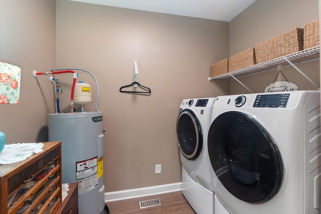 204 Locust St, Mc Ewen, TN 37101 - laundry area with electric water heater, independent washer and dryer, and wood finished floors