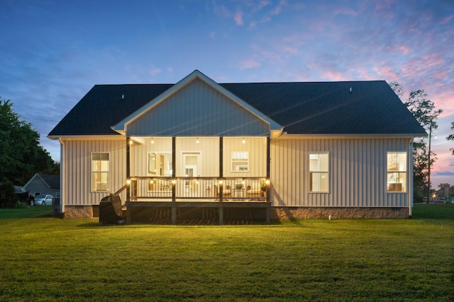 204 Locust St, Mc Ewen, TN 37101 - back of house at dusk featuring a lawn and board and batten siding
