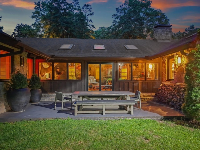 3360 Sweeney Hollow Rd, Franklin, TN 37064 - rear view of house with a patio area, board and batten siding, a chimney, a shingled roof, and a lawn