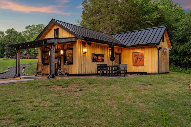 3360 Sweeney Hollow Rd, Franklin, TN 37064 - back of house at dusk featuring a standing seam roof, a yard, and a metal roof
