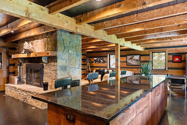 3360 Sweeney Hollow Rd, Franklin, TN 37064 - kitchen featuring a wood ceiling with exposed beams, dark wood-style floors, wooden walls, a stone fireplace, and dark stone countertops
