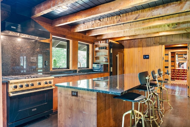 3360 Sweeney Hollow Rd, Franklin, TN 37064 - kitchen with stainless steel appliances, wall chimney exhaust hood, wooden walls, a center island, and a kitchen bar