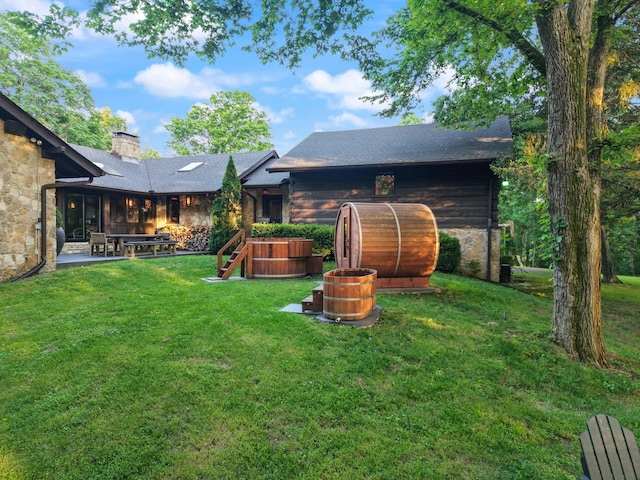 3360 Sweeney Hollow Rd, Franklin, TN 37064 - rear view of property featuring stone siding, a chimney, a yard, and a patio